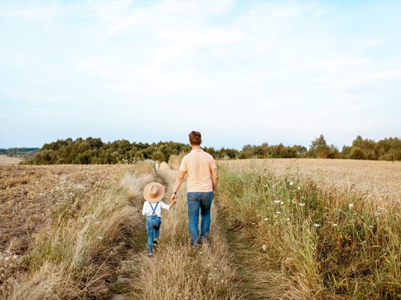 Father and son walking in the field